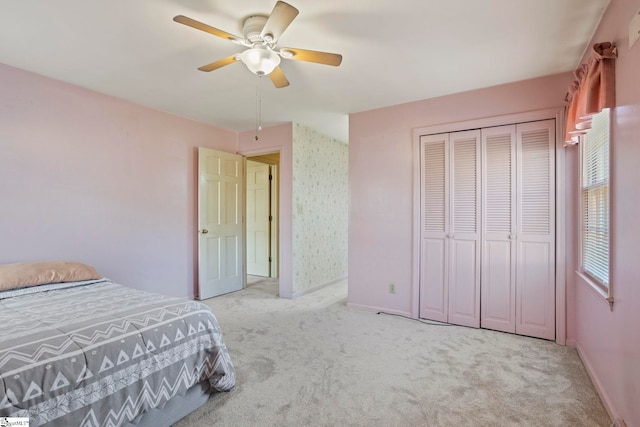 carpeted bedroom featuring a closet and ceiling fan