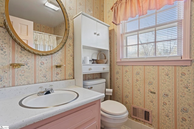 bathroom featuring toilet and vanity