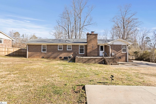 rear view of property featuring central air condition unit and a yard