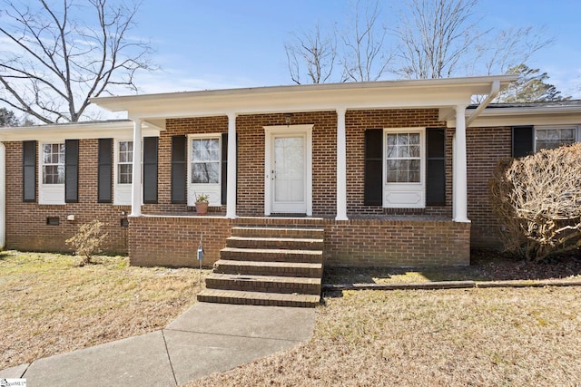 view of front of home with covered porch and a front lawn