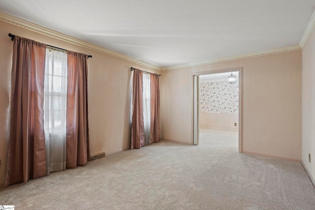 carpeted spare room featuring ornamental molding