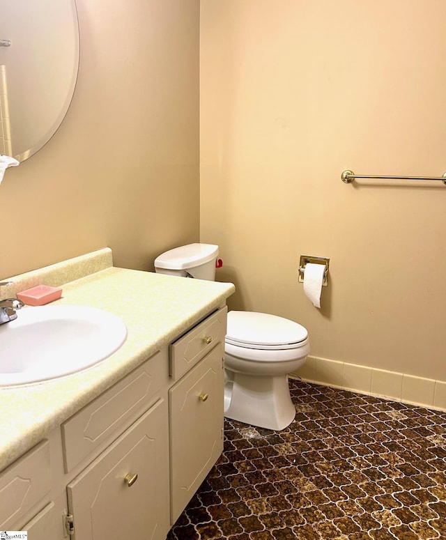 bathroom featuring toilet and vanity