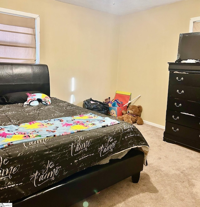 bedroom featuring light colored carpet