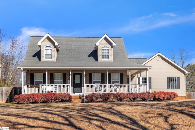 view of front of house with covered porch and a front yard