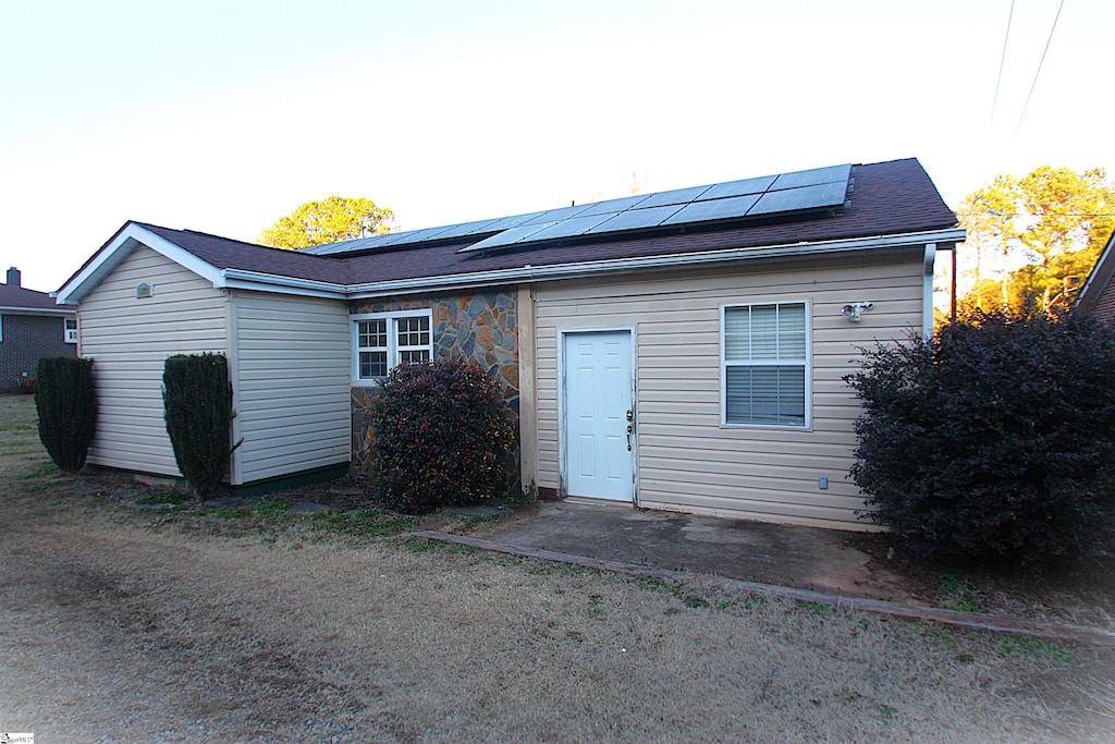 back of house with solar panels