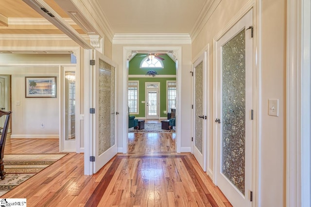 interior space with light wood-type flooring, french doors, and crown molding