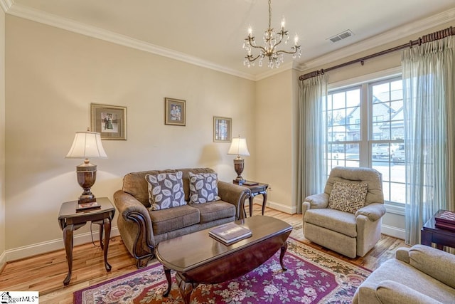 living room featuring light hardwood / wood-style flooring, crown molding, and a chandelier