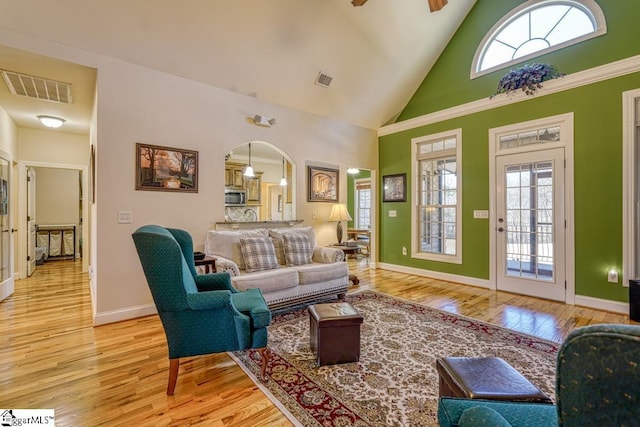 living room featuring high vaulted ceiling, light hardwood / wood-style flooring, and ceiling fan