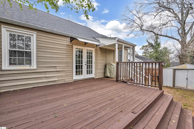 wooden terrace featuring french doors and a storage unit