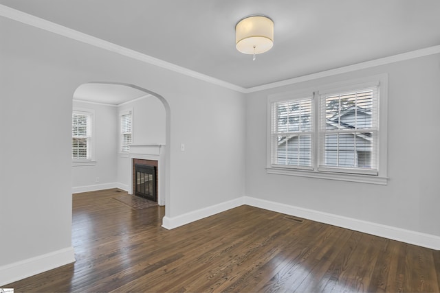 unfurnished living room with dark hardwood / wood-style floors and ornamental molding