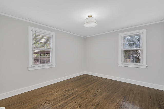 empty room with hardwood / wood-style floors, a wealth of natural light, and ornamental molding