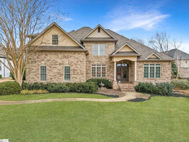 view of front facade featuring a front yard and french doors