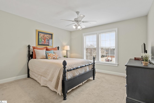 carpeted bedroom featuring ceiling fan and multiple windows