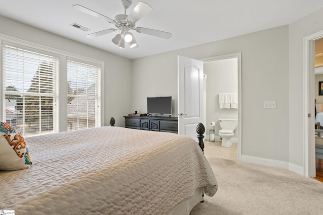 carpeted bedroom featuring ceiling fan and ensuite bath