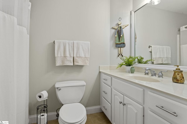 bathroom with toilet, tile patterned flooring, and vanity