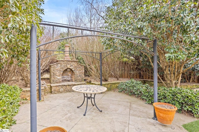 view of patio / terrace featuring an outdoor stone fireplace