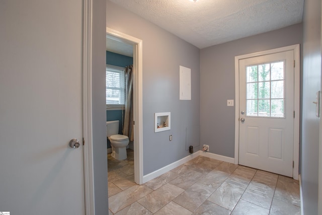 doorway featuring a textured ceiling