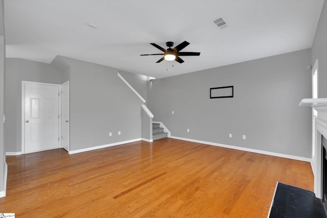 unfurnished living room with ceiling fan and wood-type flooring