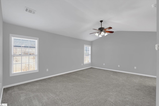 spare room featuring vaulted ceiling, carpet, and ceiling fan