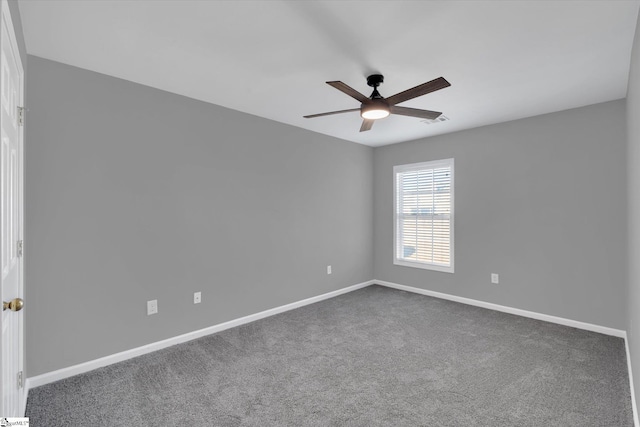 carpeted spare room featuring ceiling fan