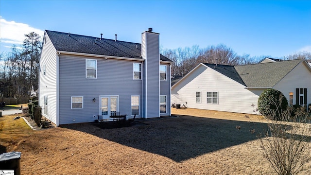 rear view of property with a yard