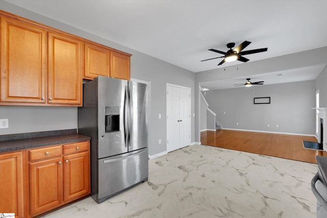 kitchen with stainless steel fridge with ice dispenser and ceiling fan