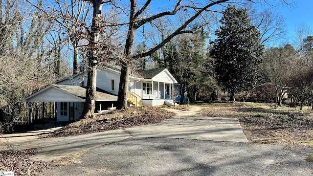 view of side of property featuring covered porch