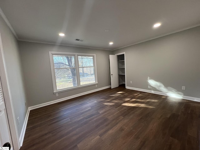 unfurnished bedroom featuring ornamental molding and dark hardwood / wood-style flooring