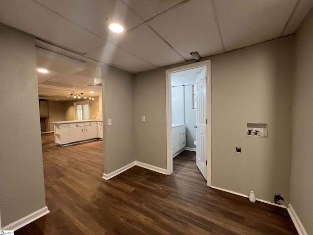 clothes washing area with hookup for a washing machine and dark hardwood / wood-style flooring