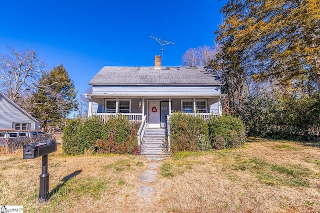 bungalow-style house with a front yard and a porch