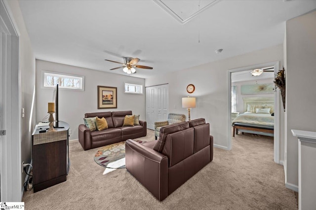 carpeted living room featuring ceiling fan