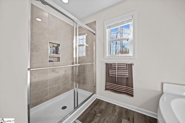 bathroom featuring hardwood / wood-style flooring and a shower with door