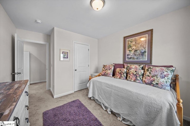 bedroom with light colored carpet and a closet