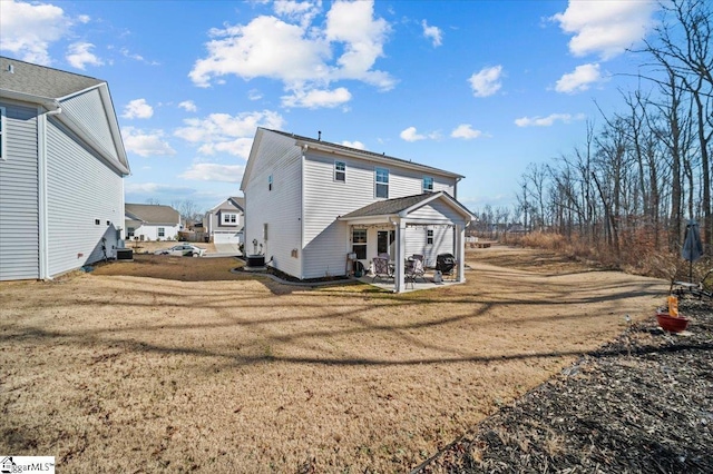 rear view of house featuring central AC unit, a patio area, and a lawn