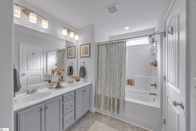 bathroom featuring shower / bath combo with shower curtain and vanity