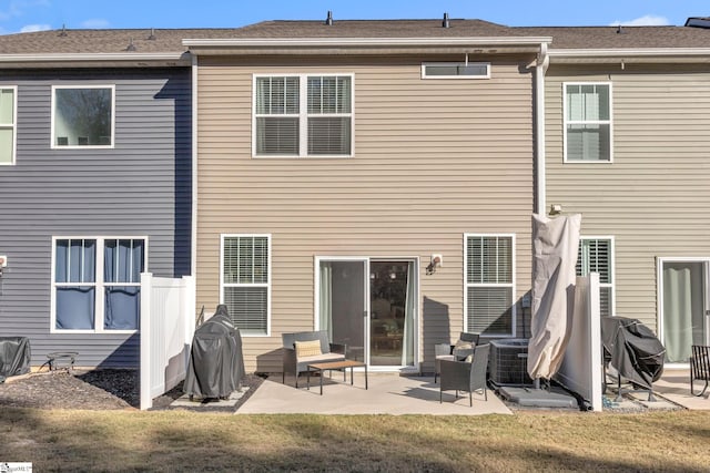 back of property with a patio area, central AC, and a yard