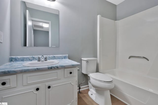 full bathroom featuring hardwood / wood-style floors, bathing tub / shower combination, toilet, and vanity