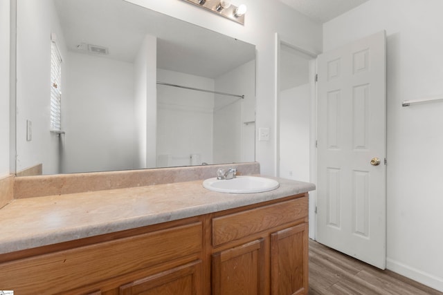 bathroom featuring hardwood / wood-style flooring and vanity