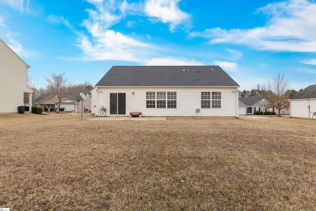 back of property featuring a patio area and a lawn