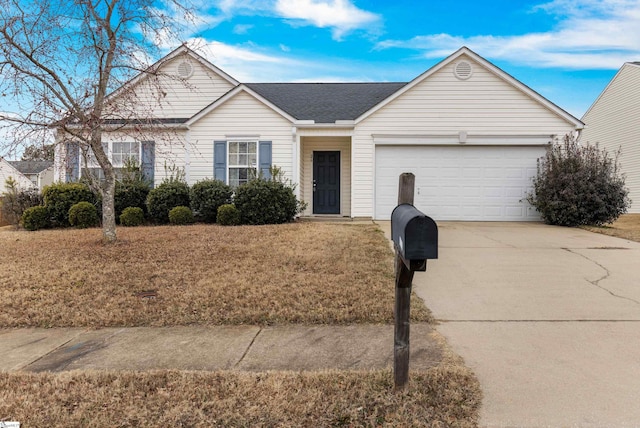 ranch-style house with a garage and a front yard