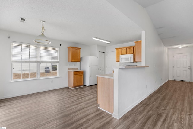 kitchen featuring white appliances, a textured ceiling, dark hardwood / wood-style flooring, hanging light fixtures, and kitchen peninsula