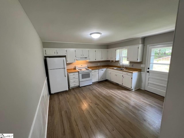 kitchen featuring hardwood / wood-style flooring, white appliances, white cabinetry, and sink