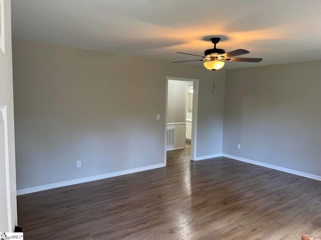 empty room with dark wood-type flooring and ceiling fan