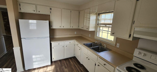 kitchen with sink, white appliances, dark wood-type flooring, and white cabinets