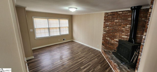 unfurnished living room featuring a wood stove, dark hardwood / wood-style flooring, and crown molding