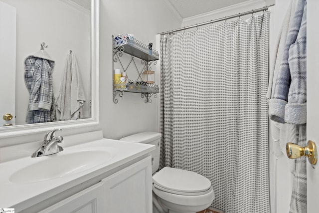 bathroom featuring a textured ceiling, toilet, vanity, and ornamental molding