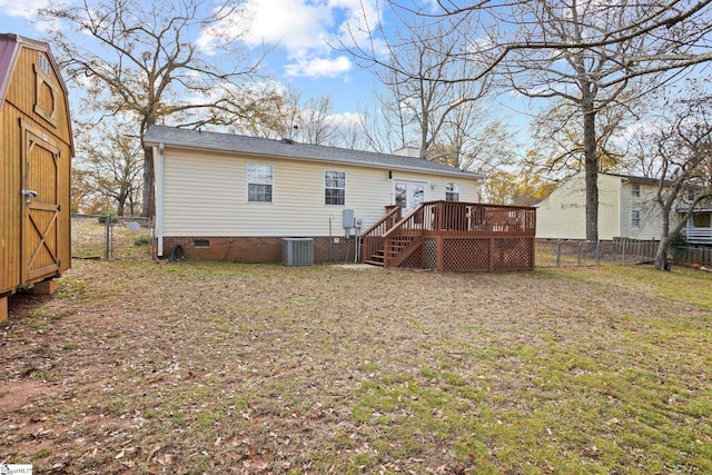 back of house featuring central AC, a deck, and a storage unit