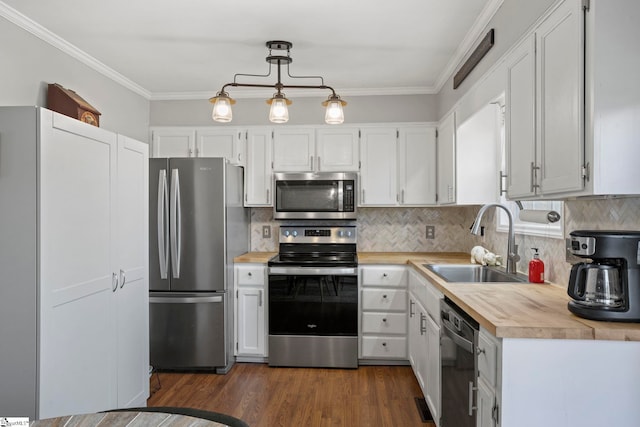 kitchen featuring pendant lighting, white cabinetry, appliances with stainless steel finishes, and sink