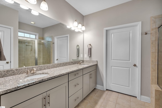 bathroom featuring tile patterned flooring, walk in shower, and vanity