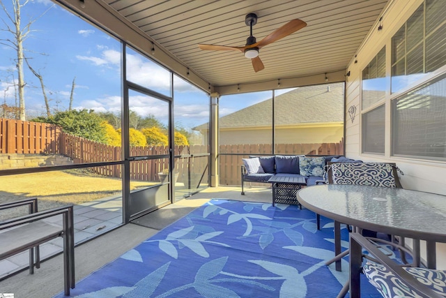 sunroom / solarium with ceiling fan and wood ceiling